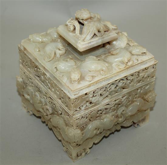 A Chinese archaistic burnt white and russet jade seal box and cover, width 12cm, height 14cm, wood stand